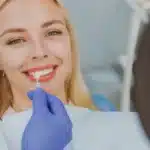 happy woman choose veneers enamel color compare teeth shade